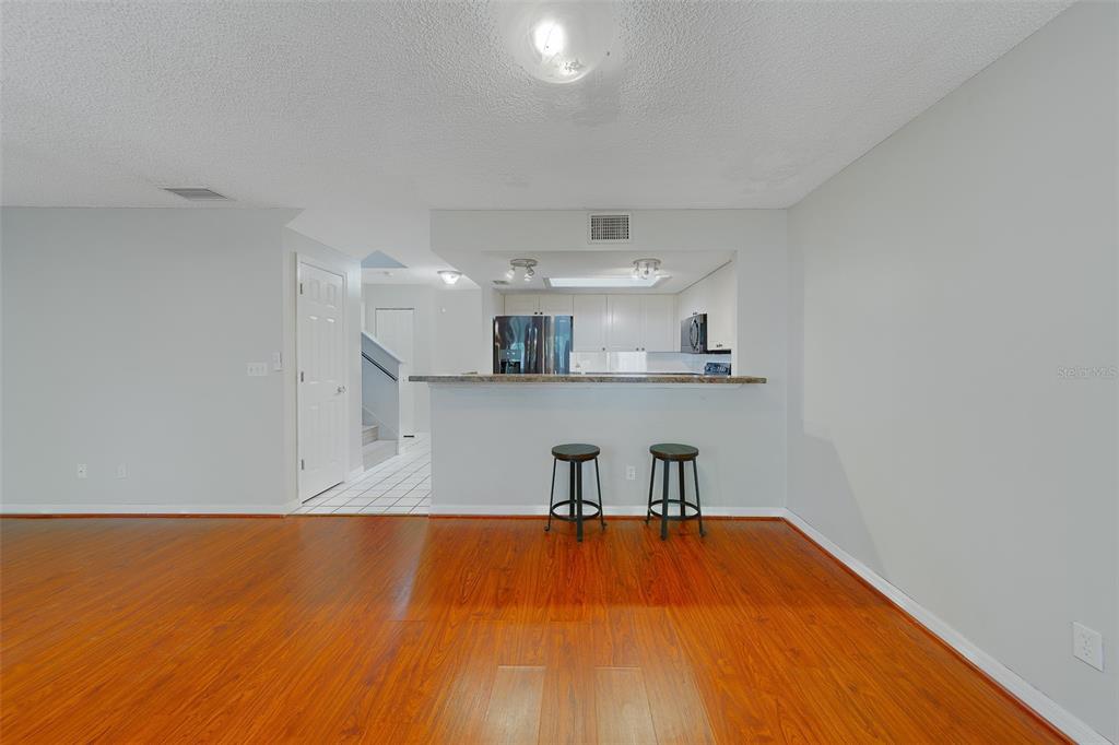 9241 Jake's Path Largo, FL 33771 - Photo 26 of 46 a view of a kitchen with wooden floor and cabinets