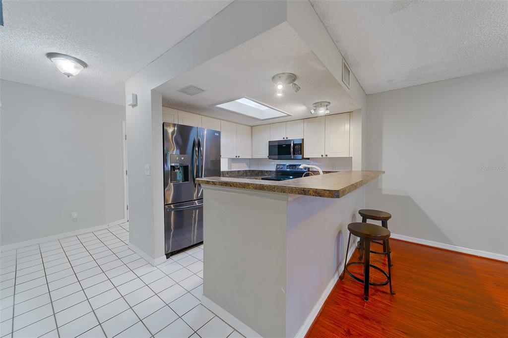 9241 Jake's Path Largo, FL 33771 - Photo 27 of 46 a kitchen with stainless steel appliances granite countertop a refrigerator and a stove top oven