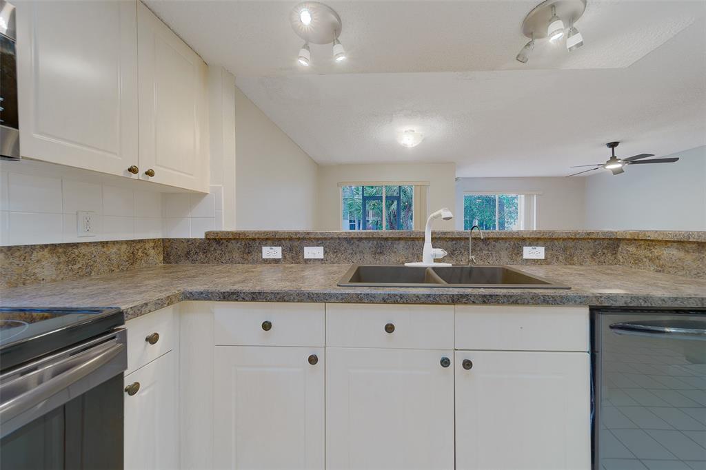 9241 Jake's Path Largo, FL 33771 - Photo 30 of 46 a kitchen with granite countertop a sink and cabinets