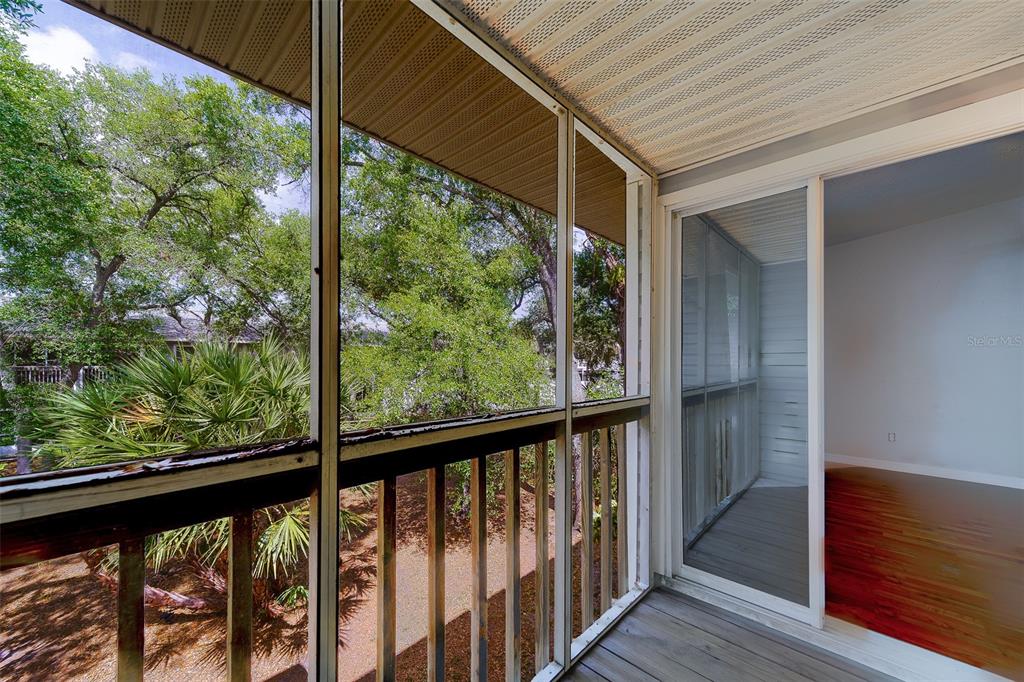 9241 Jake's Path Largo, FL 33771 - Photo 3 of 46 a view of a balcony with wooden floor