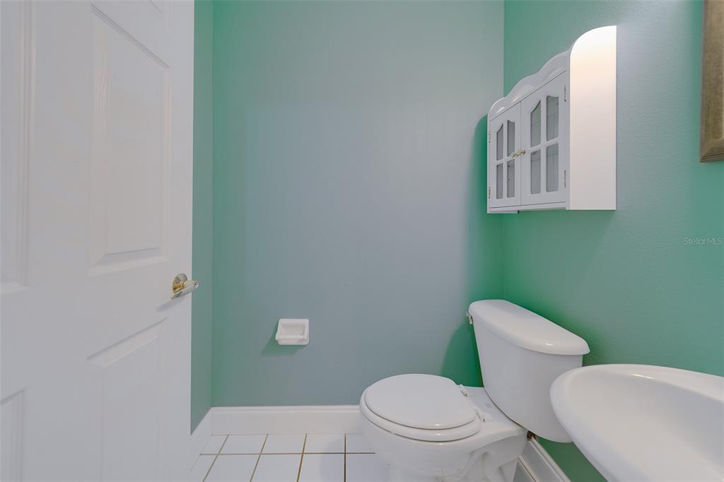 9241 Jake's Path Largo, FL 33771 - Photo 34 of 46 a white toilet sitting next to a bathroom sink