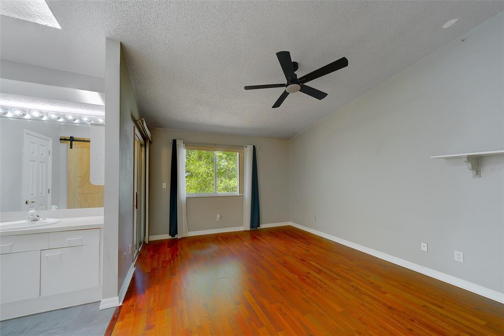 9241 Jake's Path Largo, FL 33771 - Photo 6 of 46 a bedroom with a bed and a sink