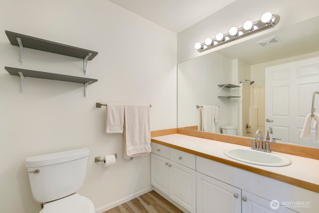 2101 North 55th Street, Unit 201 Seattle, WA 98103 - Photo 16 of 24 a bathroom with a sink double vanity and a mirror