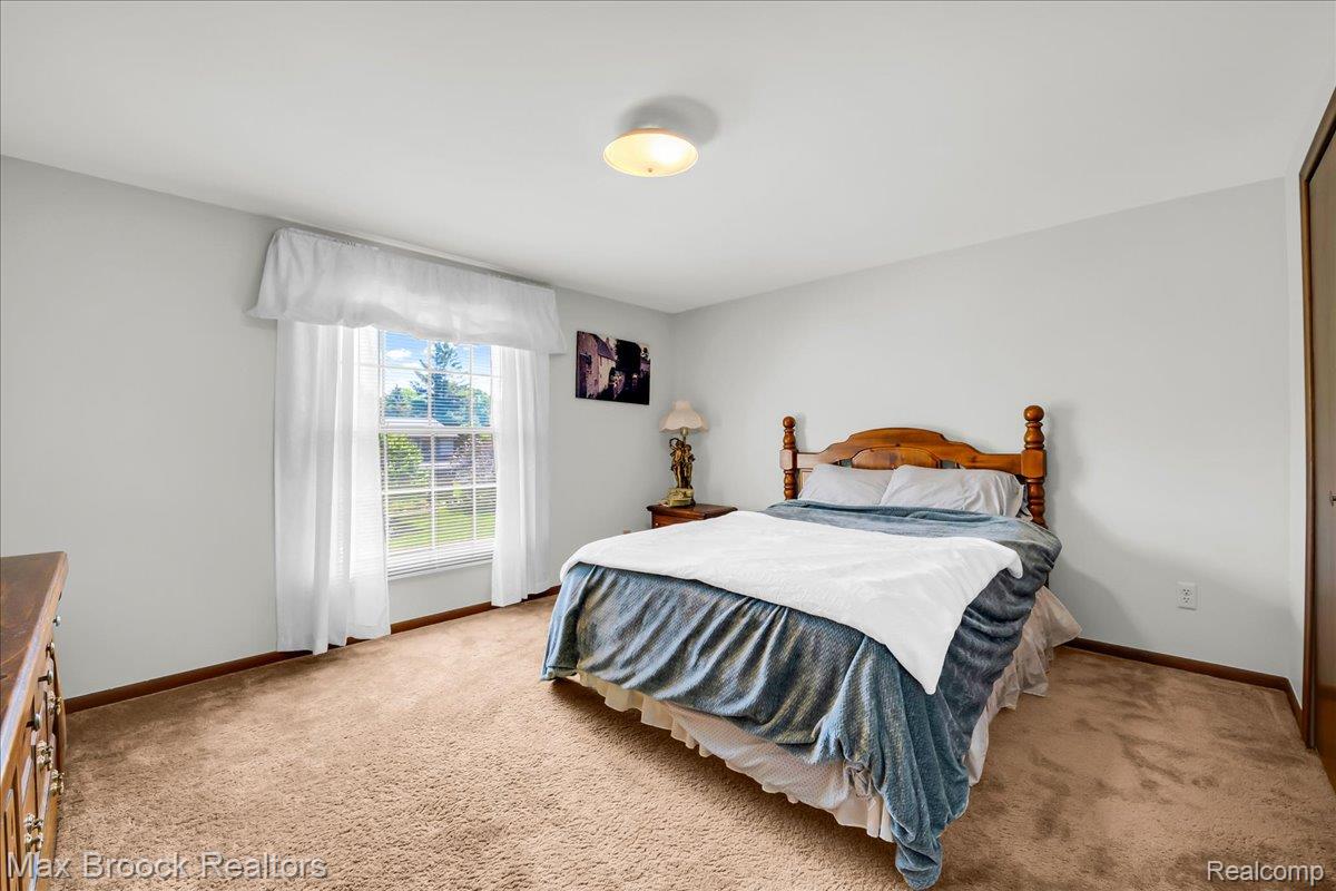 217 Stonetree Circle Rochester, MI 48309 - Photo 27 of 44 Bright interior space featuring light-colored walls and soft carpeting