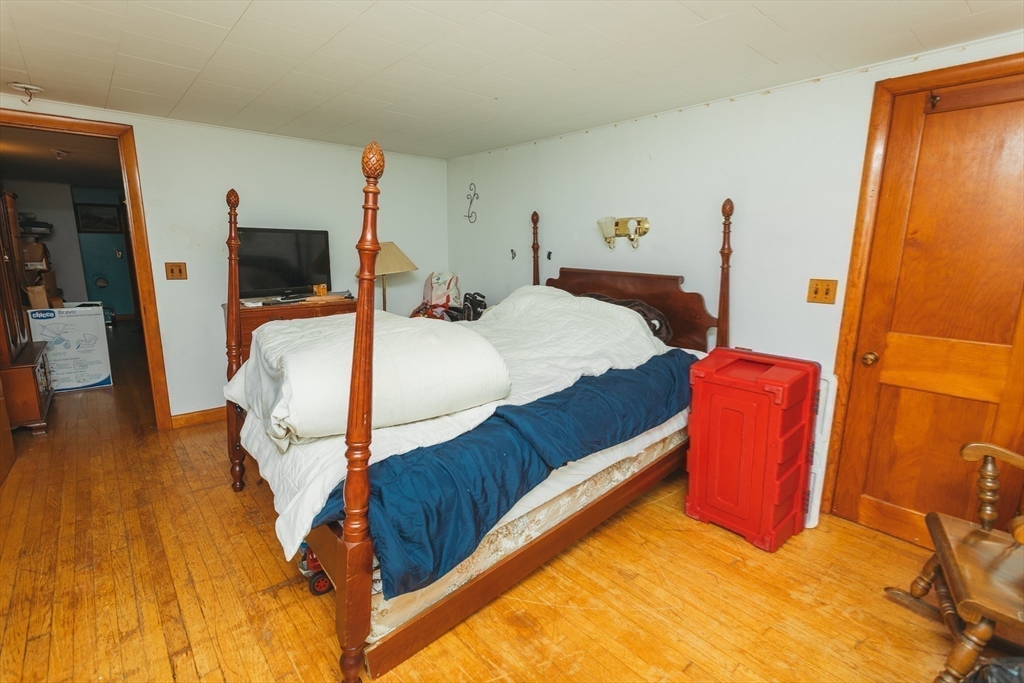 21 River Street Colrain, MA 01340 - Photo 22 of 28 a bedroom with a bed and wooden floor