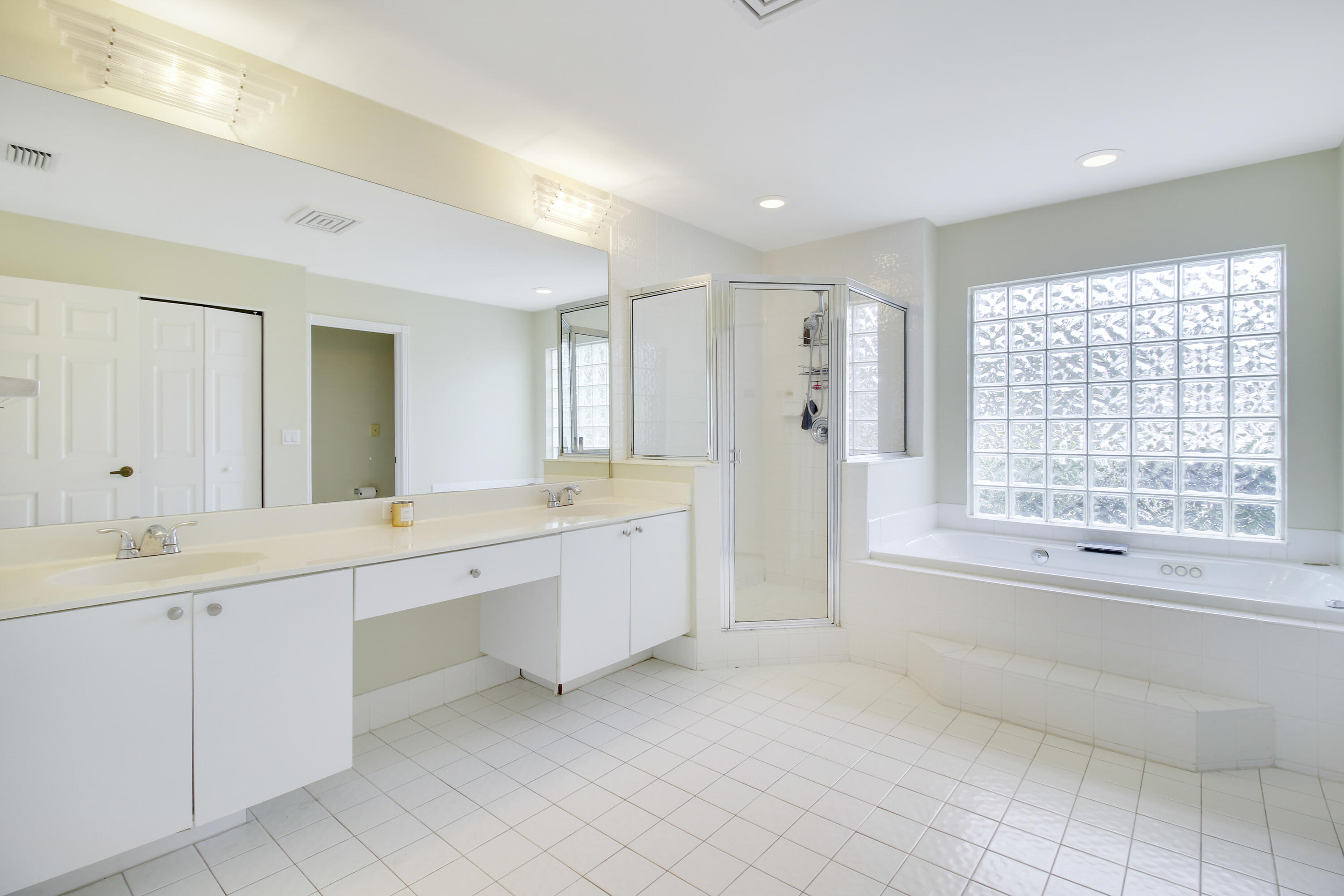 799 Cedar Cove Road Wellington, FL 33414 - Photo 11 of 44 a spacious bathroom with a double vanity sink a mirror a bathtub and next to a window