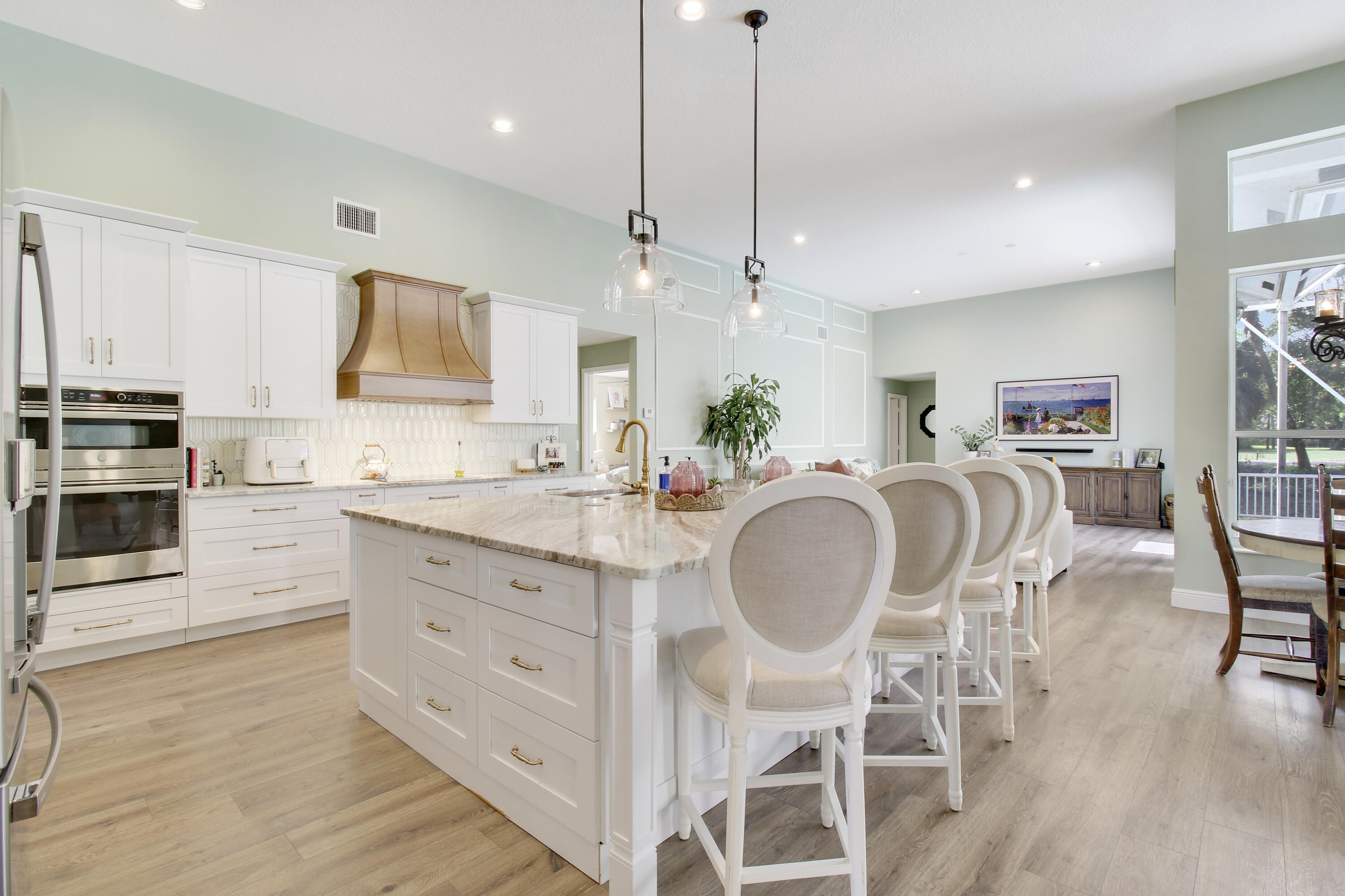 799 Cedar Cove Road Wellington, FL 33414 - Photo 14 of 44 a kitchen with stainless steel appliances kitchen island granite countertop a kitchen island hardwood floor and a sink