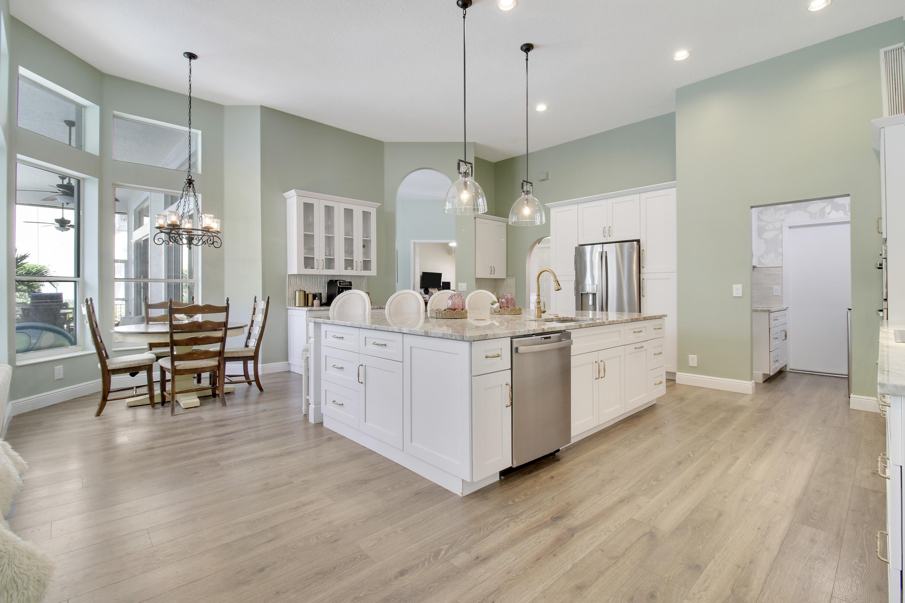 799 Cedar Cove Road Wellington, FL 33414 - Photo 18 of 44 a large white kitchen with a large island oven a stove and a wooden floors