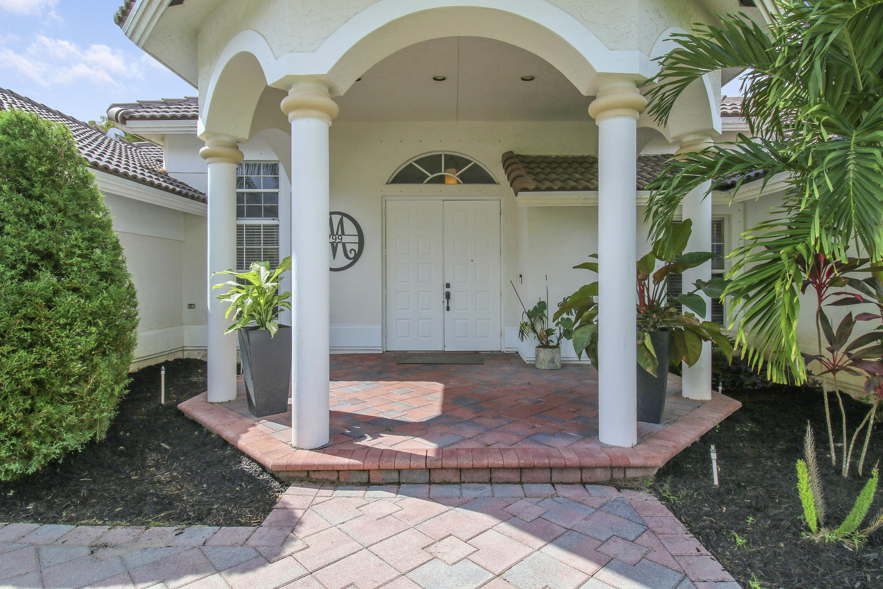 799 Cedar Cove Road Wellington, FL 33414 - Photo 2 of 44 a front view of a house with a yard