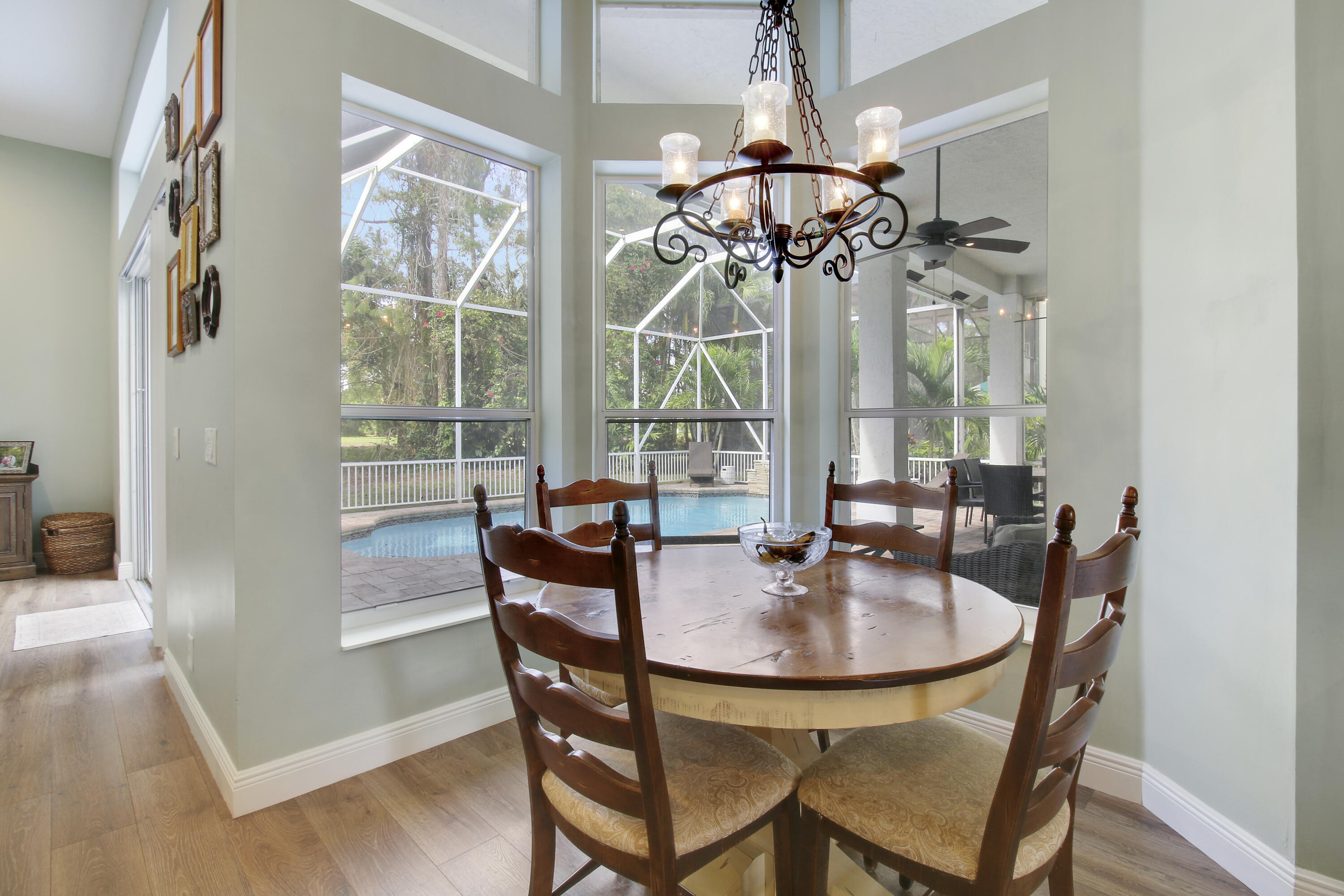 799 Cedar Cove Road Wellington, FL 33414 - Photo 21 of 44 a dining room with furniture a chandelier and wooden floor