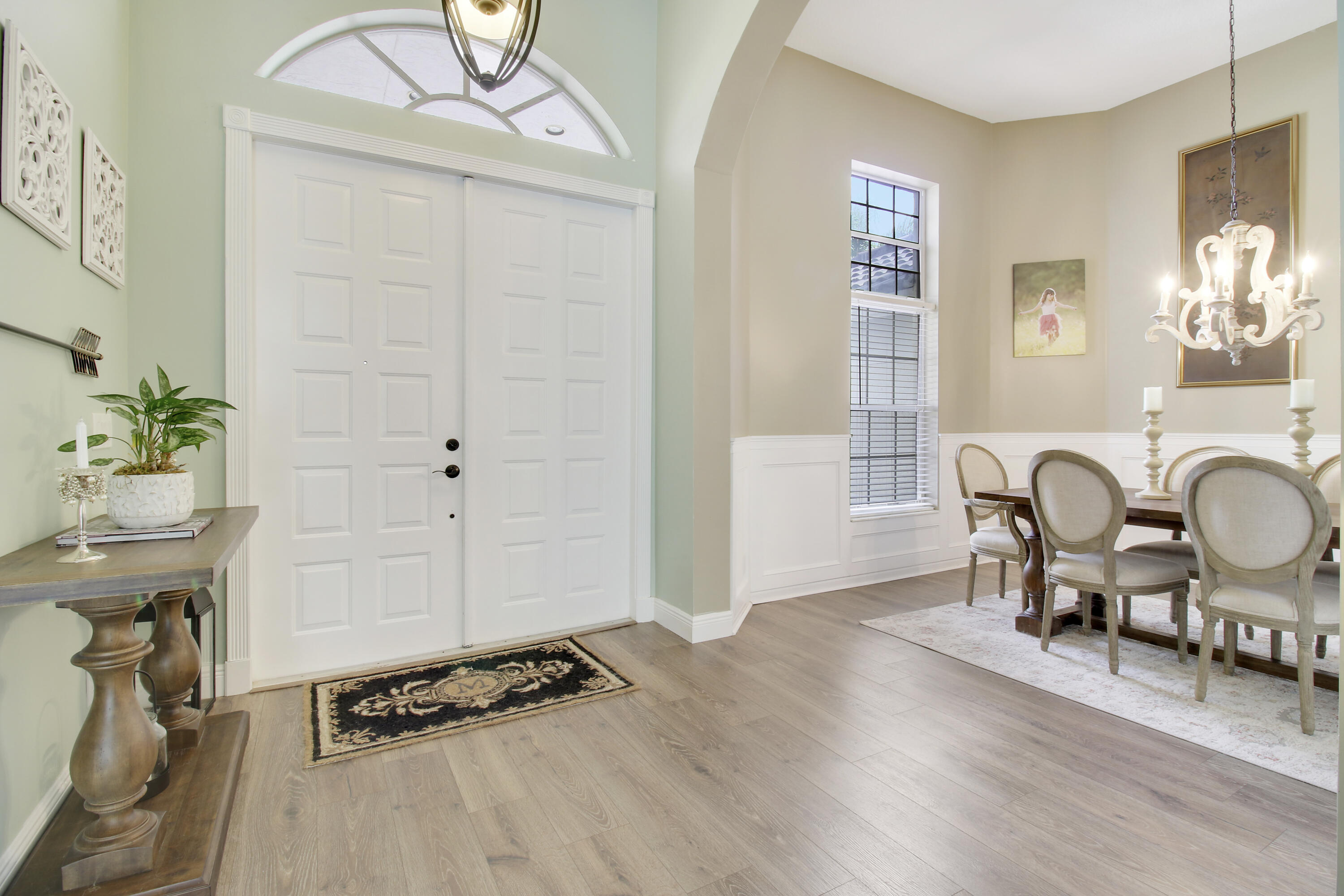 799 Cedar Cove Road Wellington, FL 33414 - Photo 3 of 44 a dining room with furniture a window and wooden floor