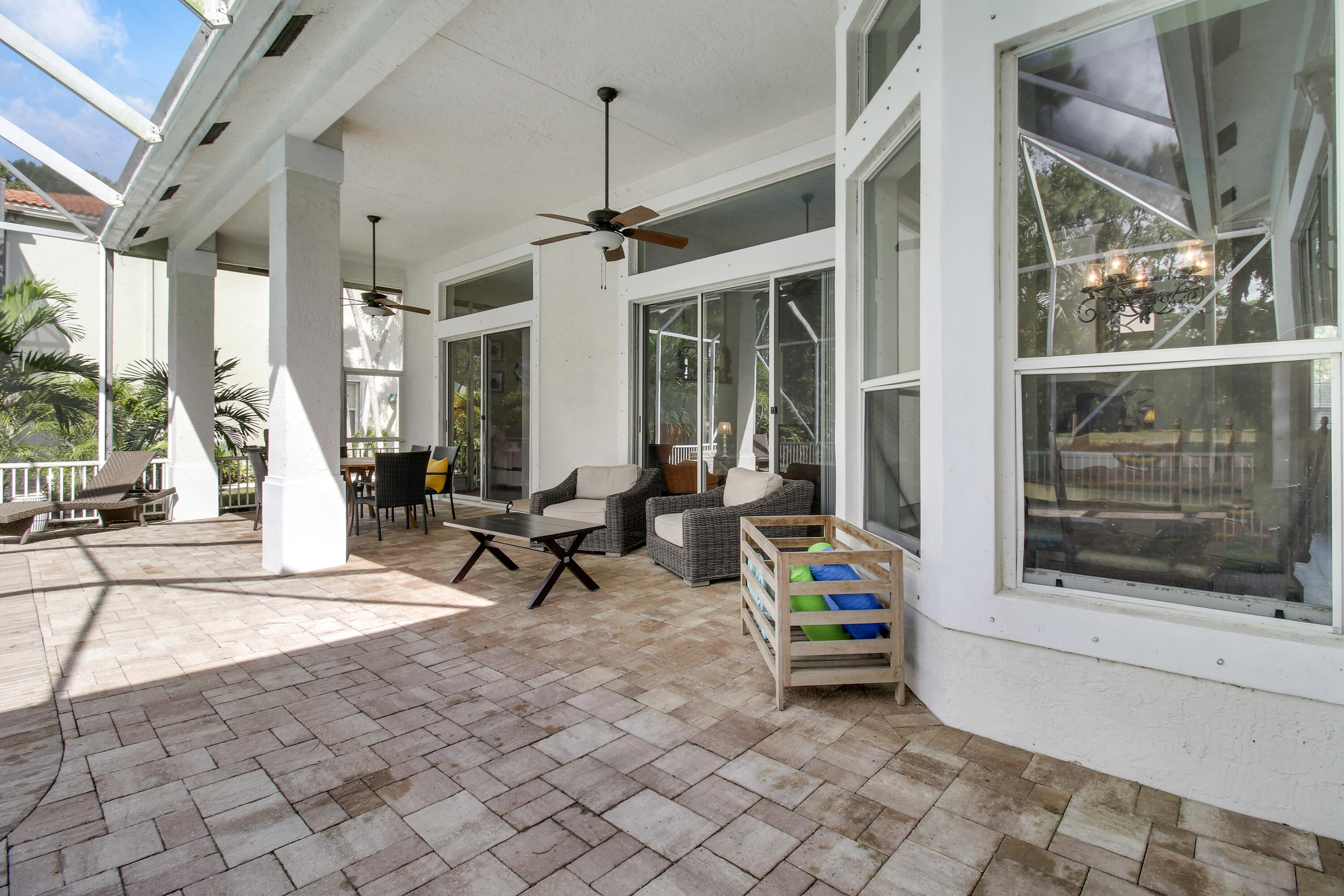 799 Cedar Cove Road Wellington, FL 33414 - Photo 32 of 44 a living room with furniture and a floor to ceiling window