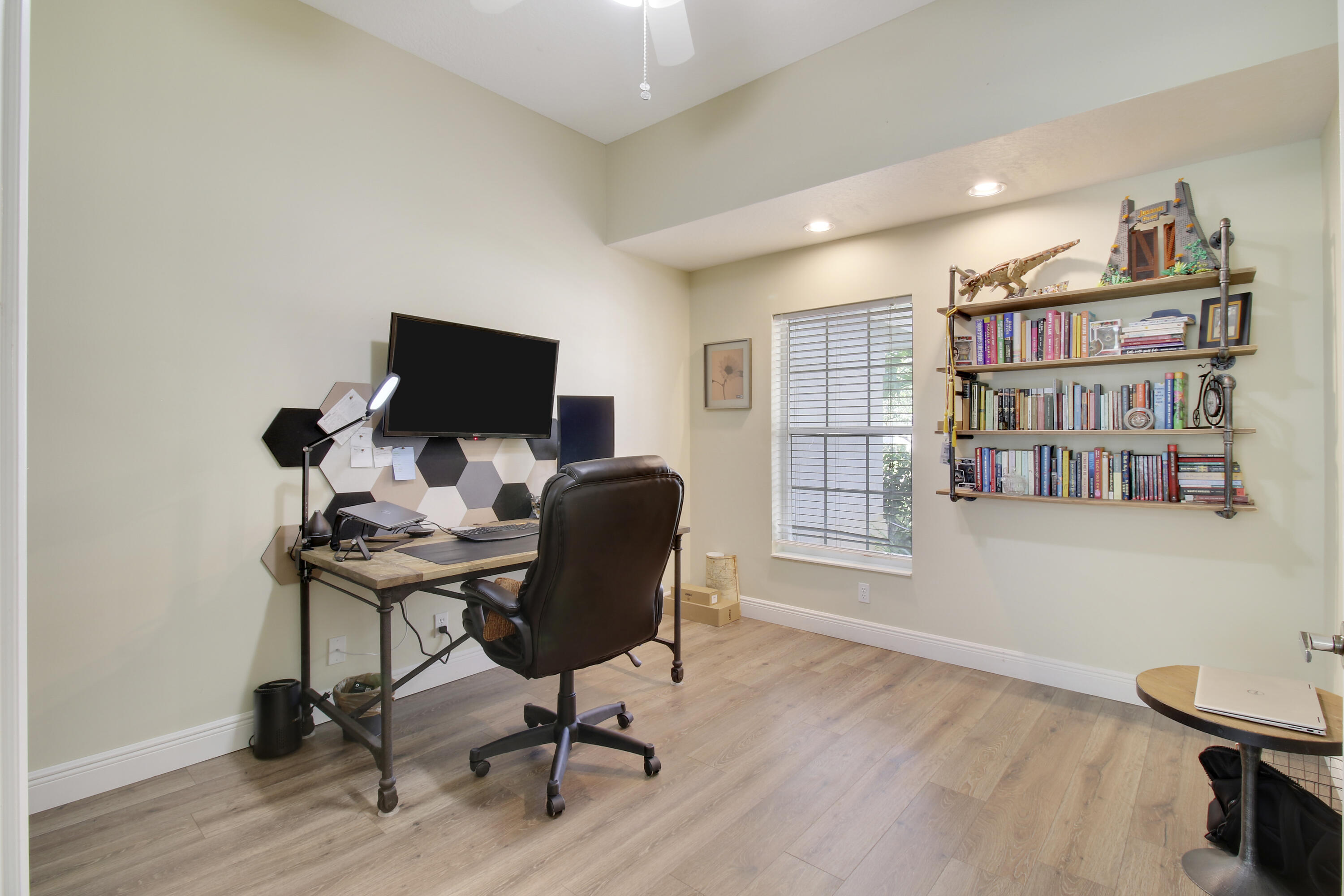 799 Cedar Cove Road Wellington, FL 33414 - Photo 7 of 44 a view of a workspace with furniture and a bookshelf