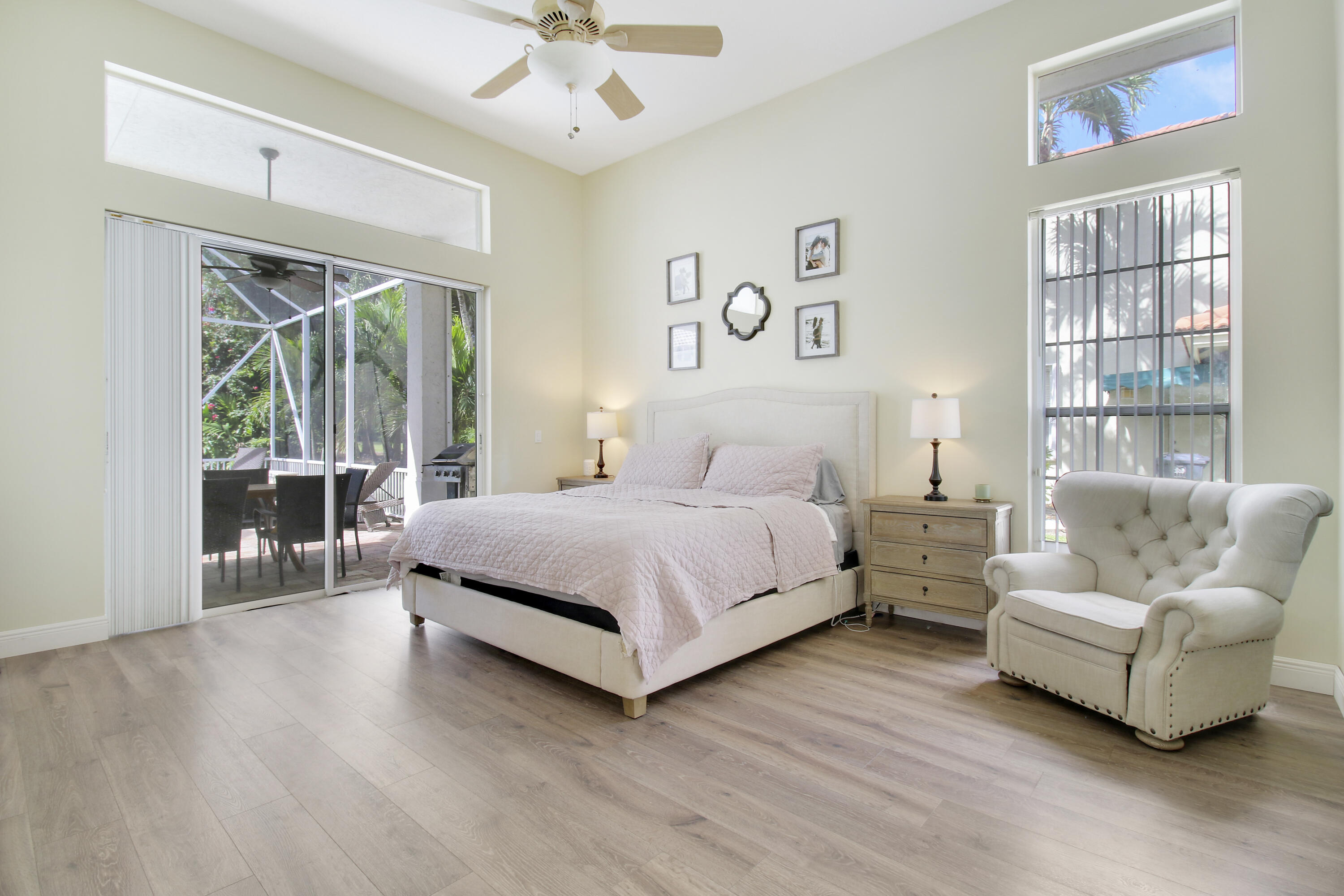 799 Cedar Cove Road Wellington, FL 33414 - Photo 8 of 44 a bedroom with a bed and glass window