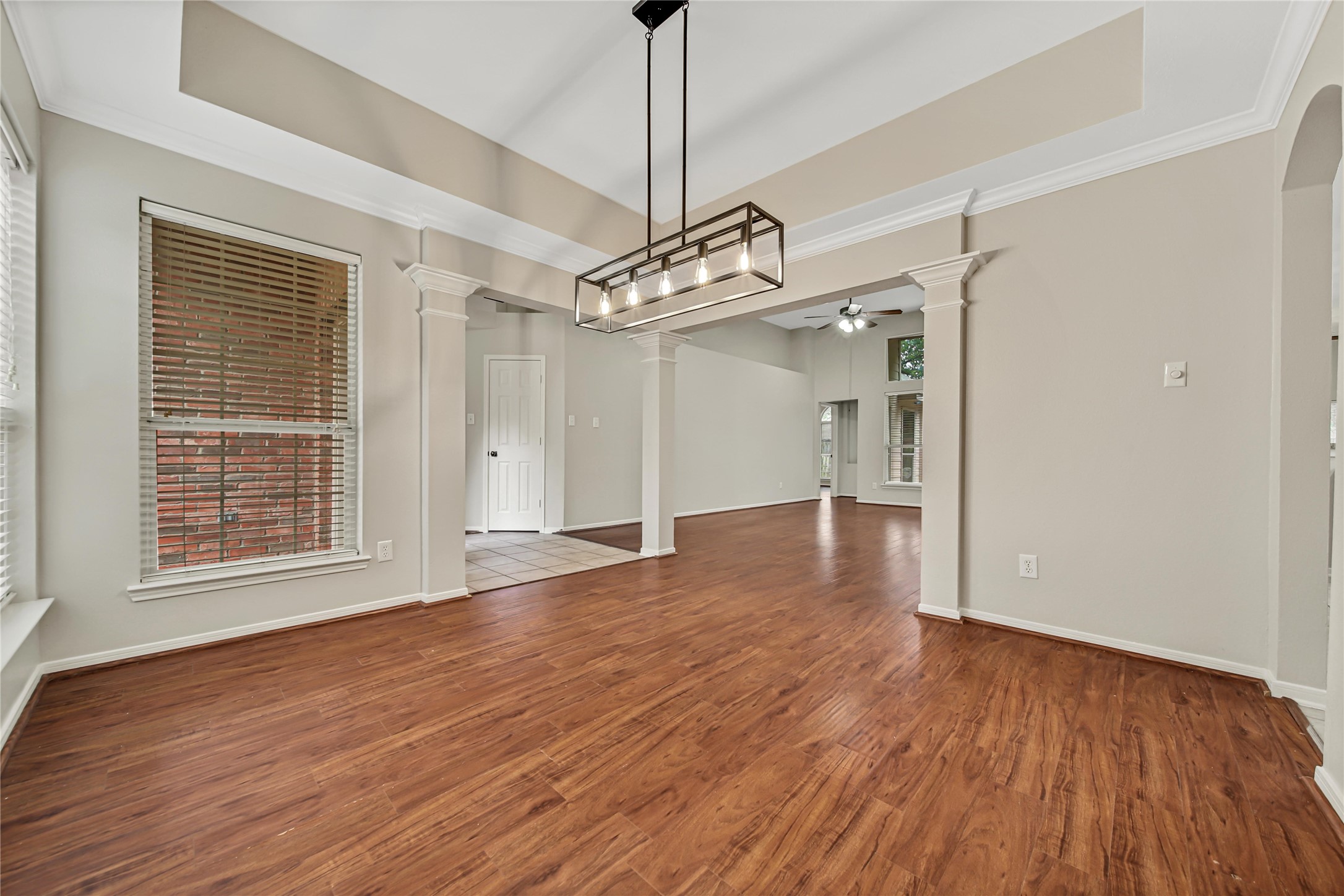 14526 Red Tailed Hawk Lane Houston, TX 77044 - Photo 36 of 40 a view of a livingroom with wooden floor a ceiling fan and windows