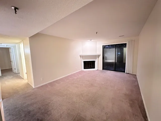 a view of empty room with a fireplace