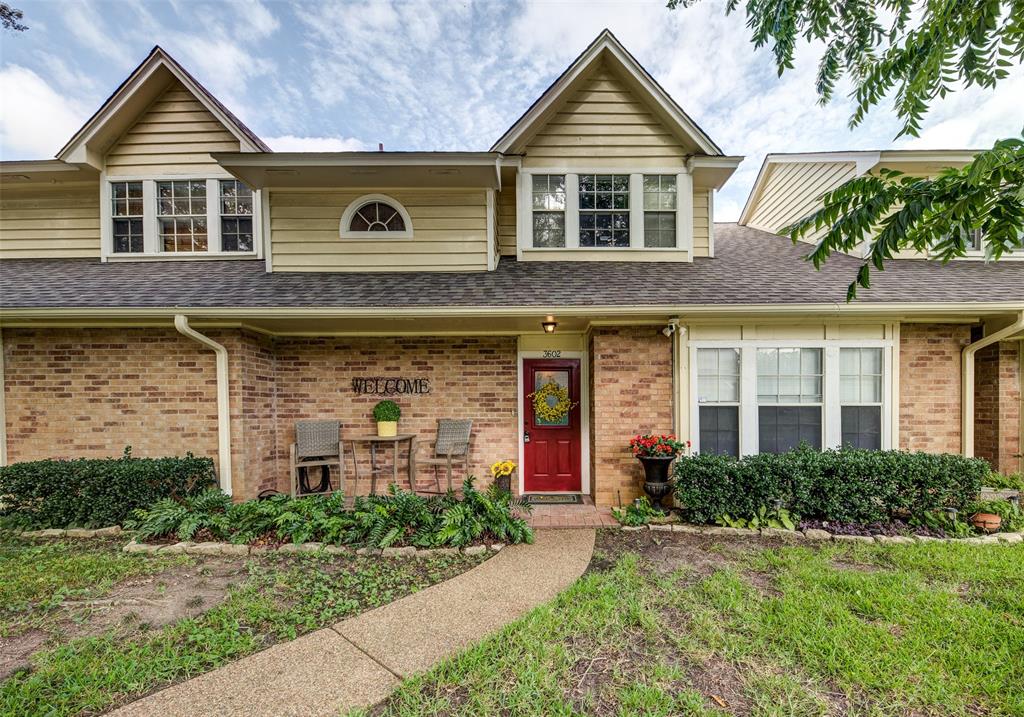 View of front facade featuring brick siding and roof with shingles