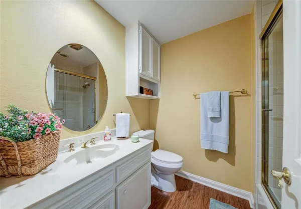 a bathroom with a toilet a sink a mirror and vanity