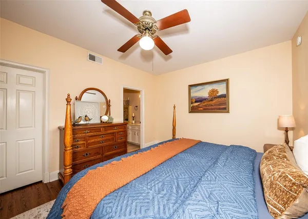 a bedroom with a bed and a dresser next to a window