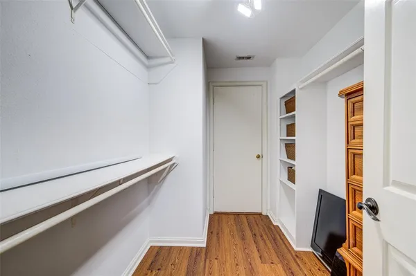 a bedroom with bed and wooden floor
