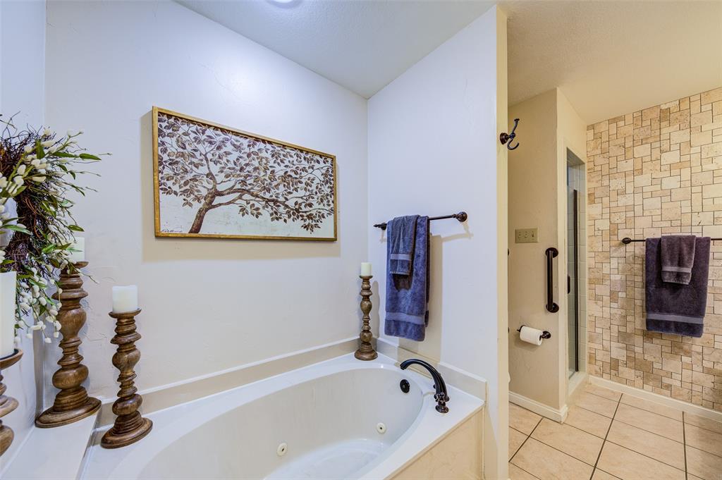 3602 Soft Wind Court Grapevine, TX 76051 - Photo 20 of 31 Full bathroom with a whirlpool tub, tile patterned flooring, and a shower stall