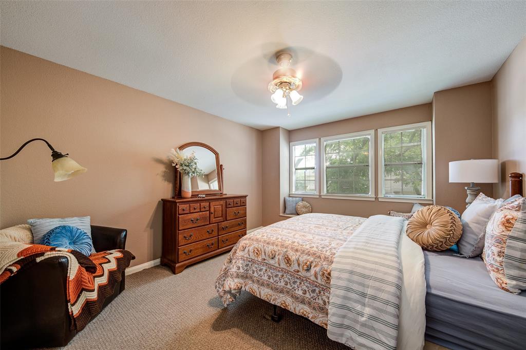 3602 Soft Wind Court Grapevine, TX 76051 - Photo 22 of 31 Bedroom featuring light carpet and a ceiling fan