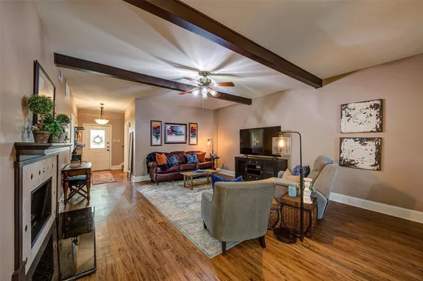 a living room with furniture fireplace and flat screen tv