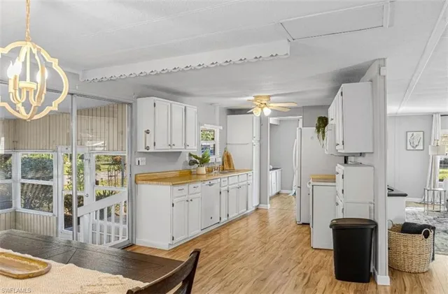 a large kitchen with a lot of counter space and wooden floor