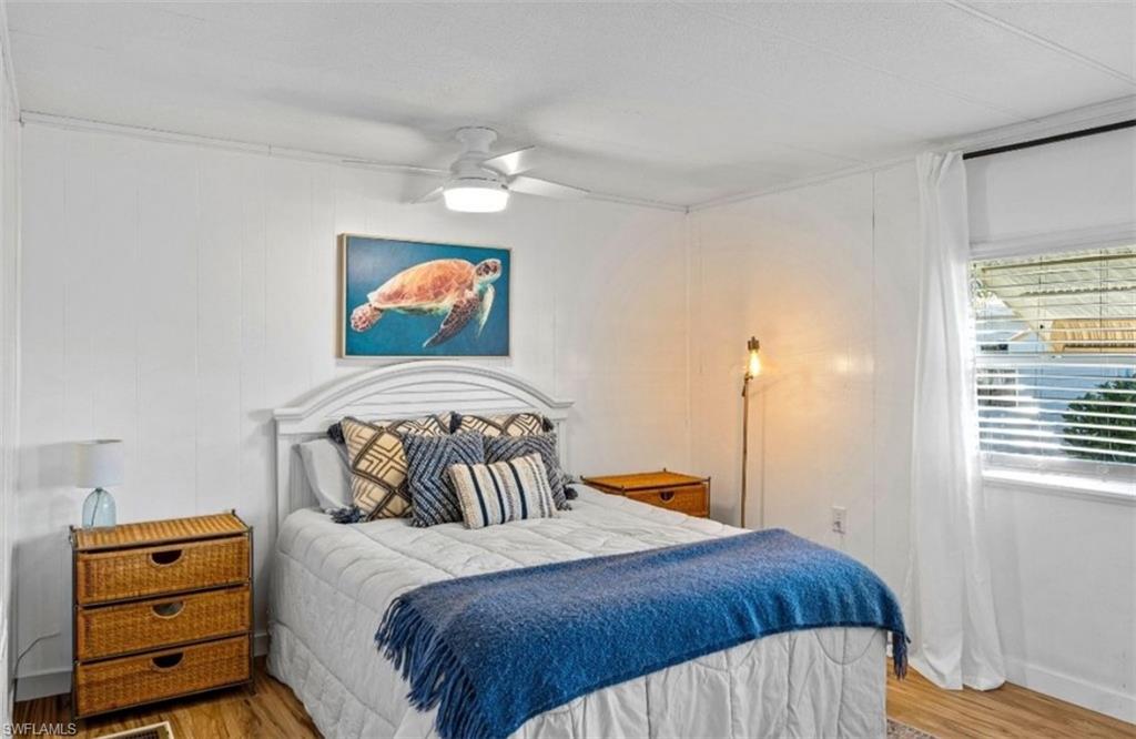 407 Cape Florida Way Naples, FL 34104 - Photo 17 of 27 Bedroom with wood finished floors and ceiling fan