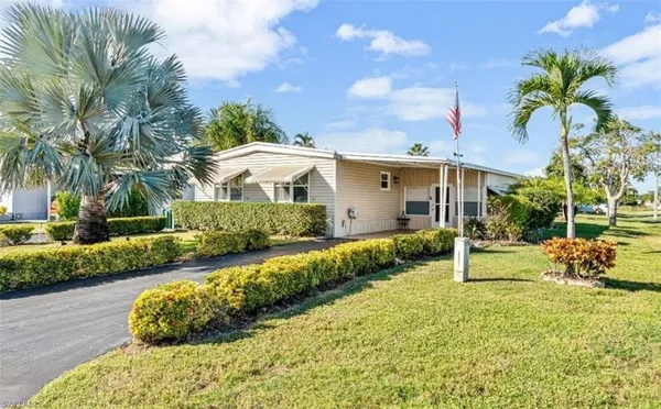 a view of a house with a yard and a garden