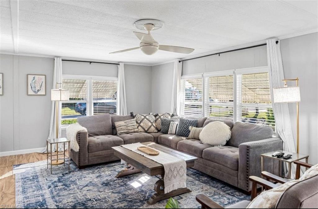407 Cape Florida Way Naples, FL 34104 - Photo 3 of 27 Living room featuring wood finished floors and ceiling fan