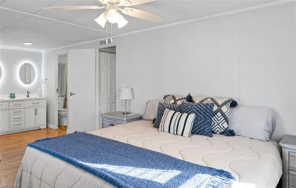 a bedroom with a large bed and a chandelier