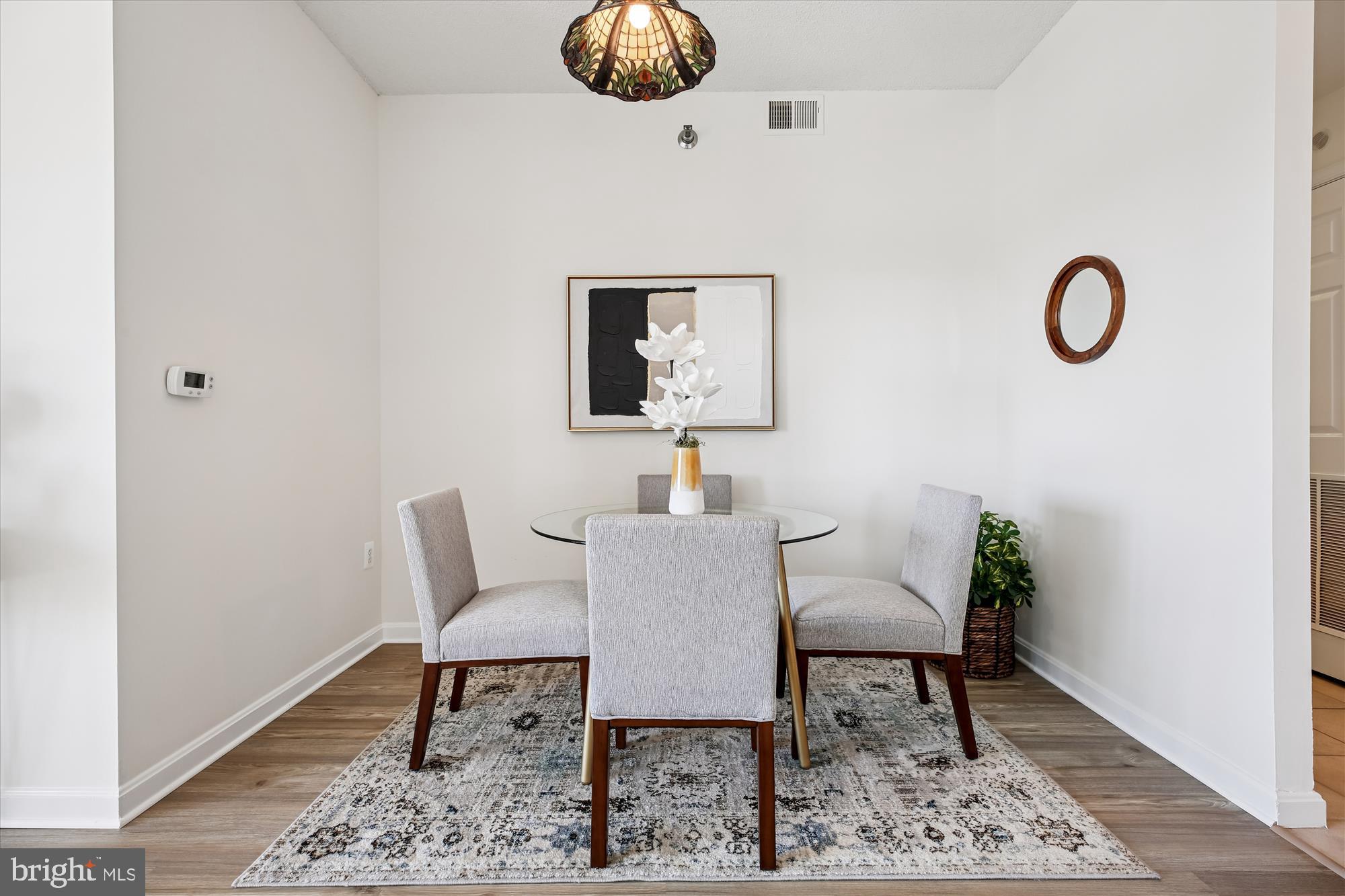 3005 South Leisure World Boulevard, Unit 802 Silver Spring, MD 20906 - Photo 12 of 70 a view of a dining room with furniture and wooden floor