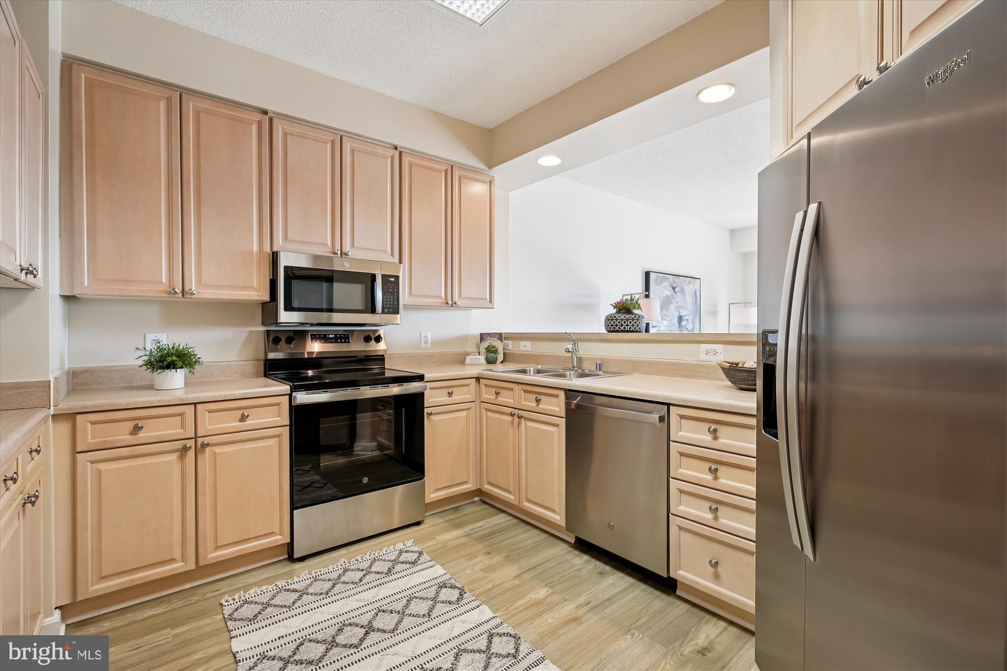 3005 South Leisure World Boulevard, Unit 802 Silver Spring, MD 20906 - Photo 18 of 70 a kitchen with stainless steel appliances white cabinets a sink and a stove