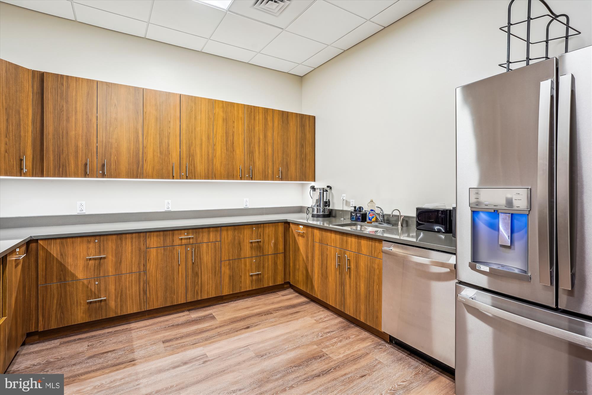 3005 South Leisure World Boulevard, Unit 802 Silver Spring, MD 20906 - Photo 61 of 70 a kitchen with stainless steel appliances granite countertop a refrigerator a sink dishwasher and wooden cabinets with wooden floor