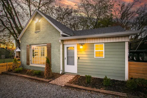 a view of house and tree in front of it