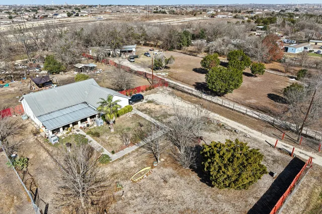 an aerial view of a house with a yard and lake view