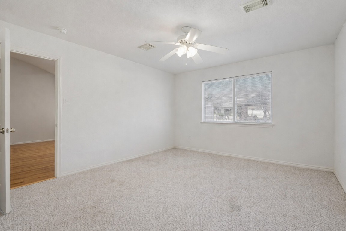 2001 Goforth Road Kyle, TX 78640 - Photo 12 of 34 an empty room with windows and fan