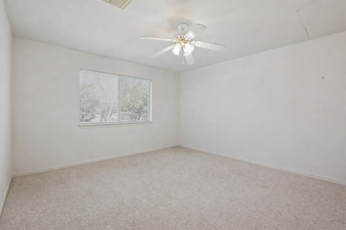 2001 Goforth Road Kyle, TX 78640 - Photo 13 of 34 an empty room with a chandelier fan