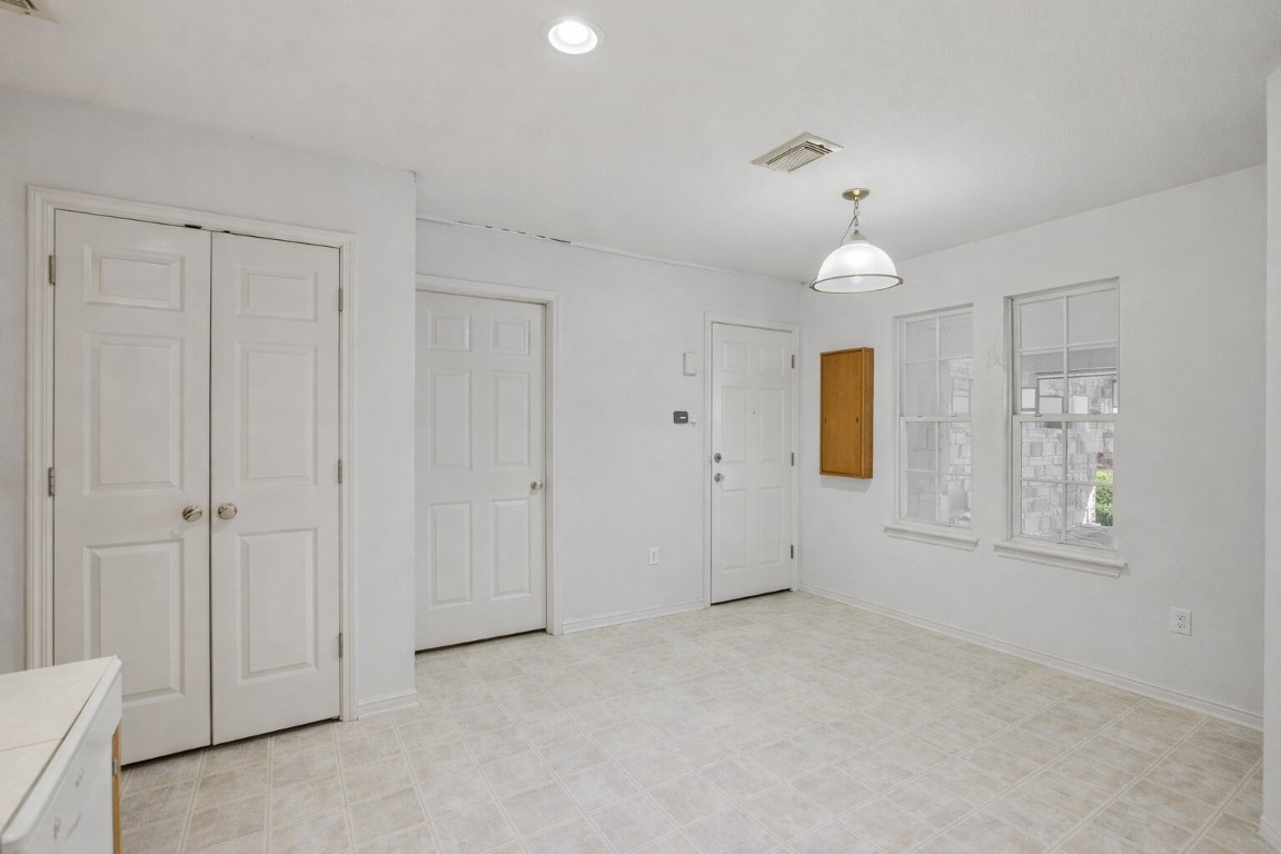 2001 Goforth Road Kyle, TX 78640 - Photo 18 of 34 an empty room with windows and a chandelier fan