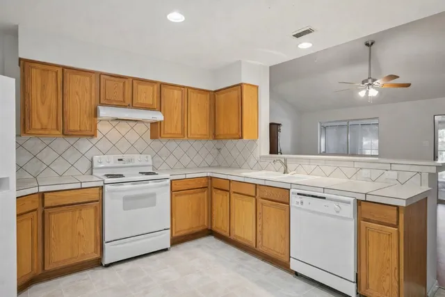 a kitchen with a sink stove and cabinets