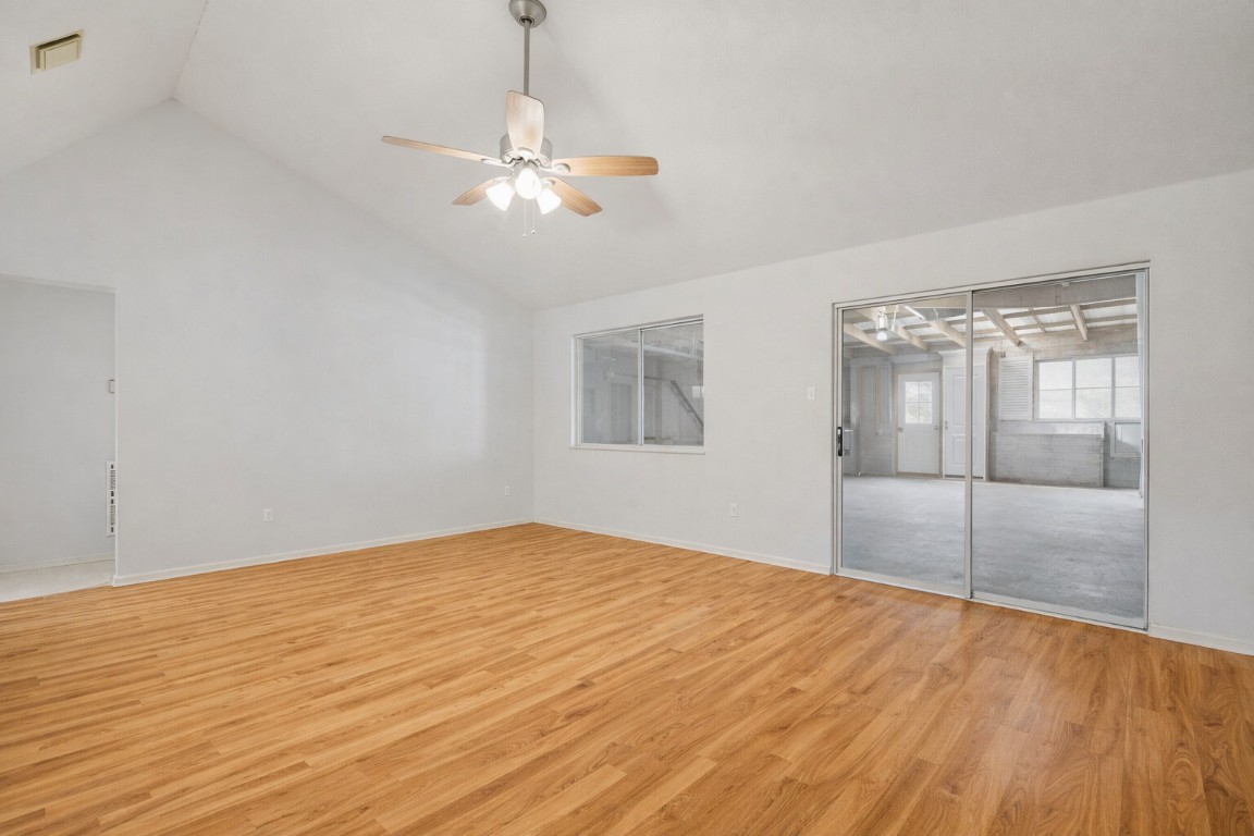 2001 Goforth Road Kyle, TX 78640 - Photo 9 of 34 a view of an empty room with wooden floor and fan