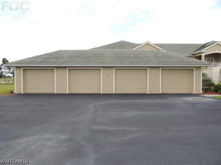 2280 Somerset Ridge Drive, Unit 101 Lehigh Acres, FL 33973 - Photo 1 of 12 a house view with a outdoor space