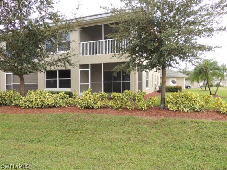 2280 Somerset Ridge Drive, Unit 101 Lehigh Acres, FL 33973 - Photo 12 of 12 front view of a house with a yard