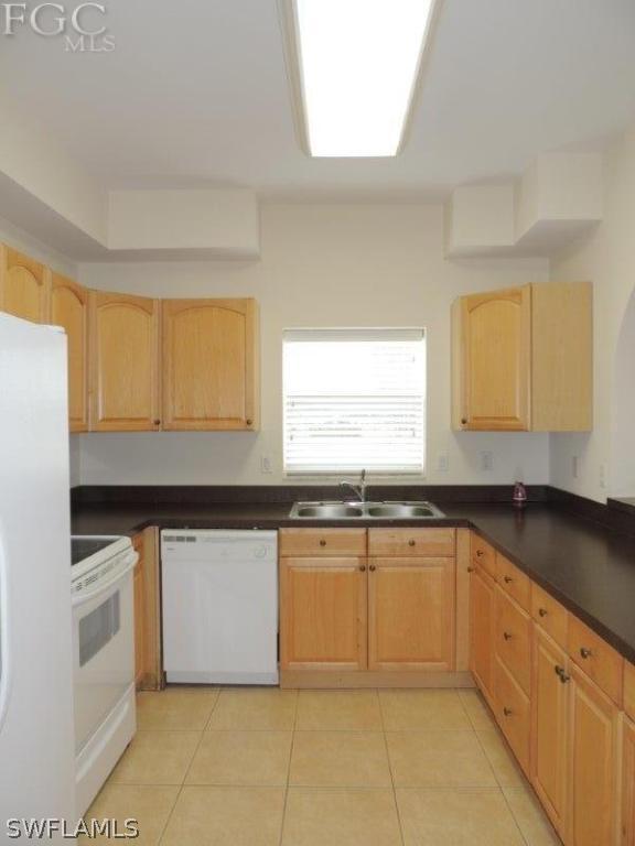 2280 Somerset Ridge Drive, Unit 101 Lehigh Acres, FL 33973 - Photo 2 of 12 a kitchen with granite countertop a sink window and cabinets