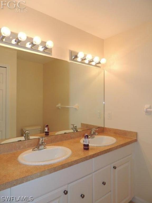 2280 Somerset Ridge Drive, Unit 101 Lehigh Acres, FL 33973 - Photo 5 of 12 a bathroom with a sink and a mirror