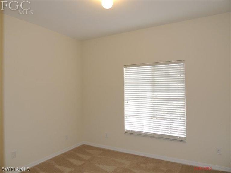 2280 Somerset Ridge Drive, Unit 101 Lehigh Acres, FL 33973 - Photo 8 of 12 a view of a room that has a window in it