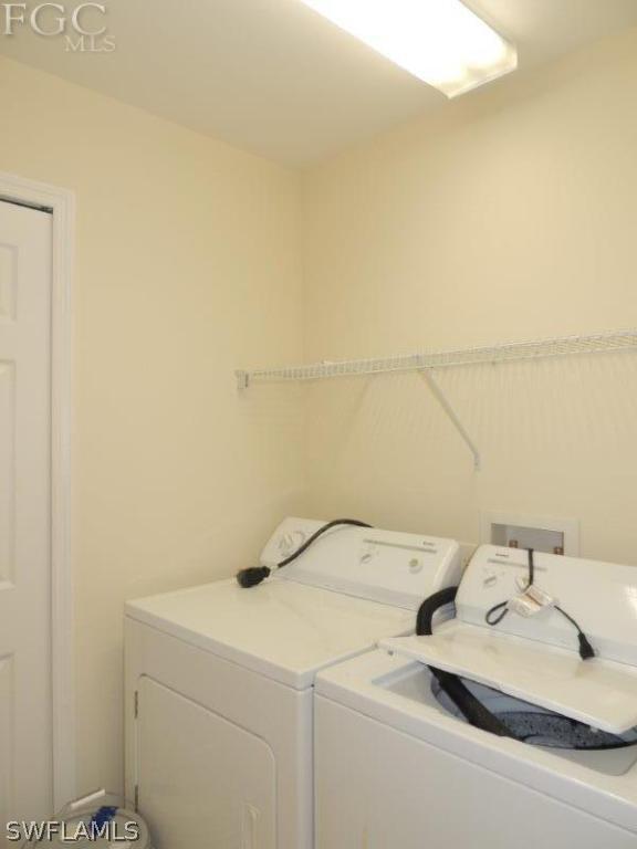 2280 Somerset Ridge Drive, Unit 101 Lehigh Acres, FL 33973 - Photo 9 of 12 a utility room with dryer and washer