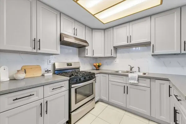 a kitchen with white cabinets and white appliances