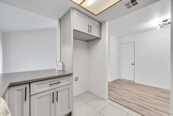 a kitchen with white cabinets and a sink